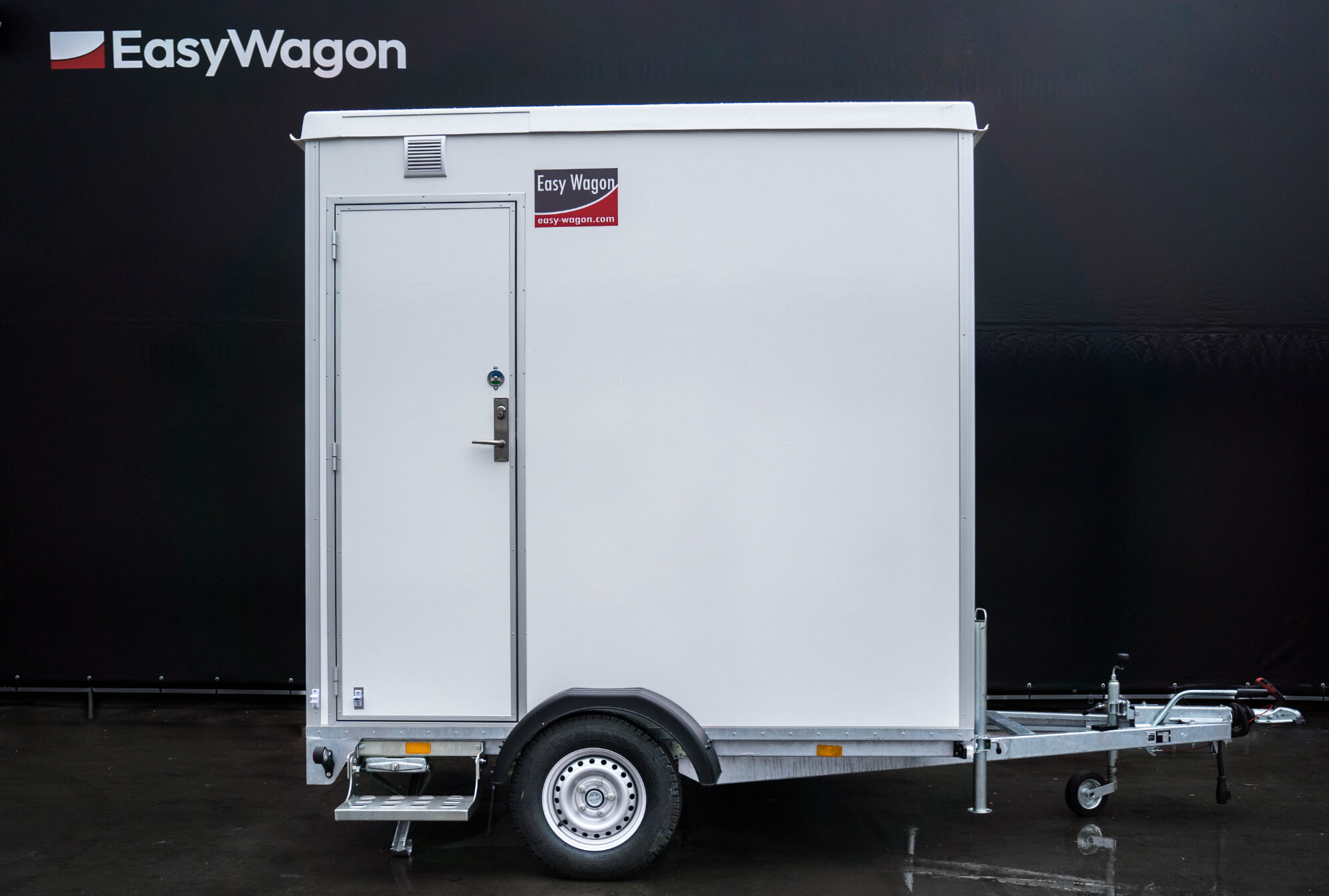 Eight shirts arranged on table in black, olive, grey, blue, white, red, mustard, and green.